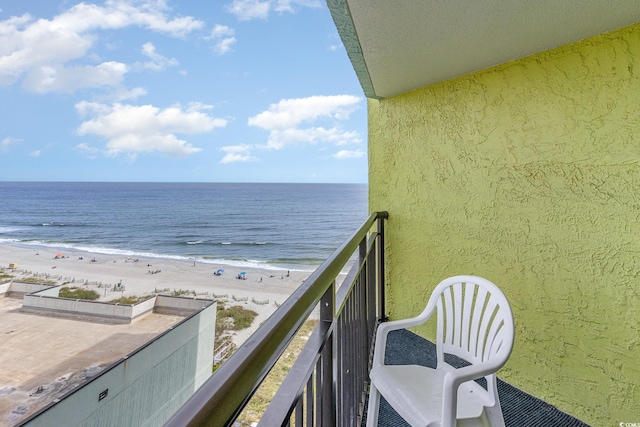 balcony with a water view and a beach view