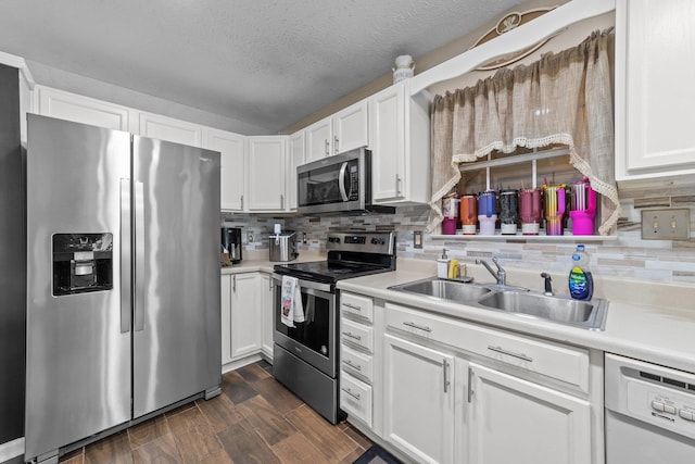 kitchen featuring white cabinets, appliances with stainless steel finishes, and sink