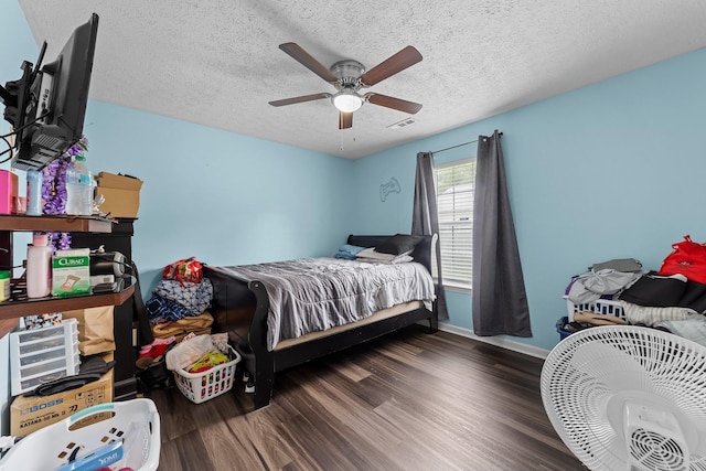 bedroom featuring a textured ceiling, dark hardwood / wood-style flooring, and ceiling fan