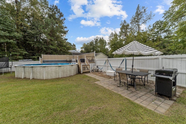 view of yard with a fenced in pool and a patio area