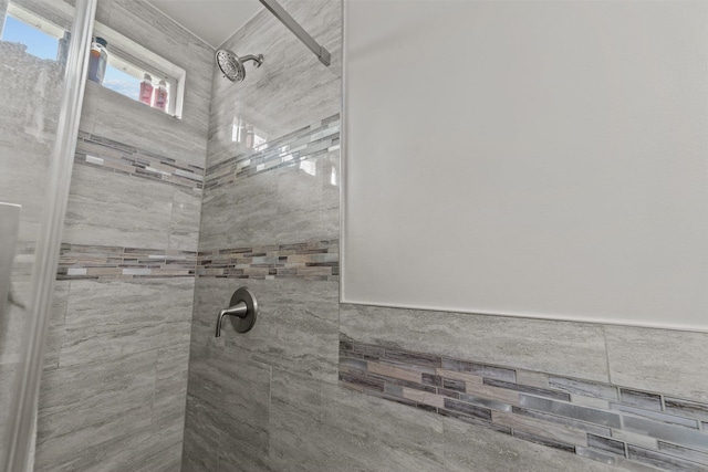 bathroom with a tile shower