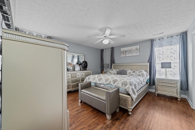 bedroom featuring a textured ceiling, dark hardwood / wood-style flooring, and ceiling fan