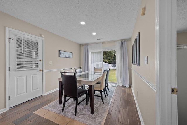 dining room featuring dark hardwood / wood-style floors and a textured ceiling