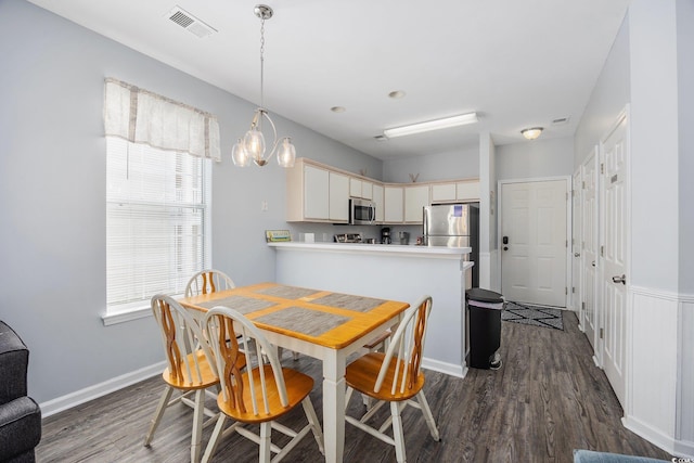 dining space featuring dark hardwood / wood-style floors