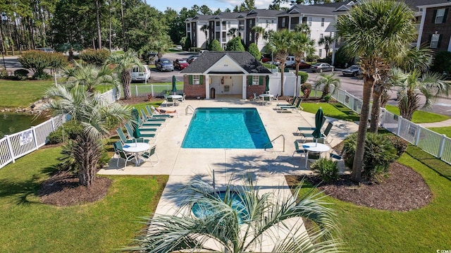 view of swimming pool featuring a yard and a patio