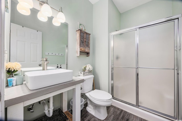 bathroom with walk in shower, toilet, sink, an inviting chandelier, and hardwood / wood-style floors