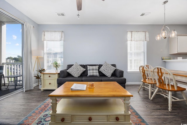 living room featuring ceiling fan and dark hardwood / wood-style flooring