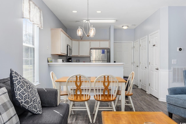 dining room featuring an inviting chandelier and dark wood-type flooring