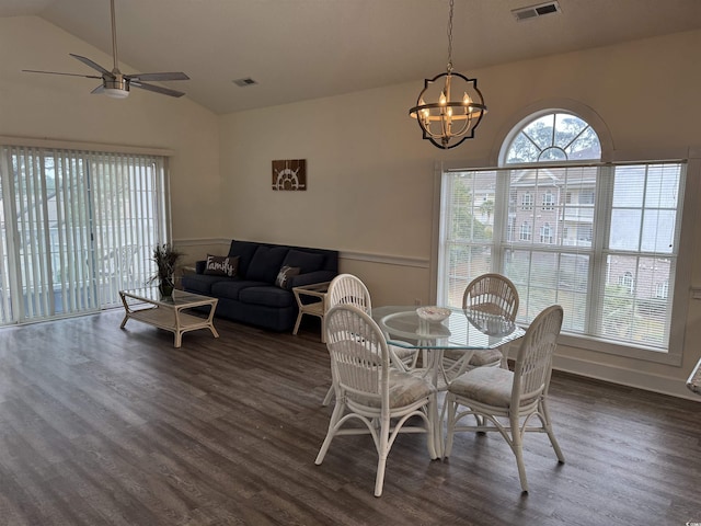 dining area with ceiling fan with notable chandelier, a wealth of natural light, and lofted ceiling