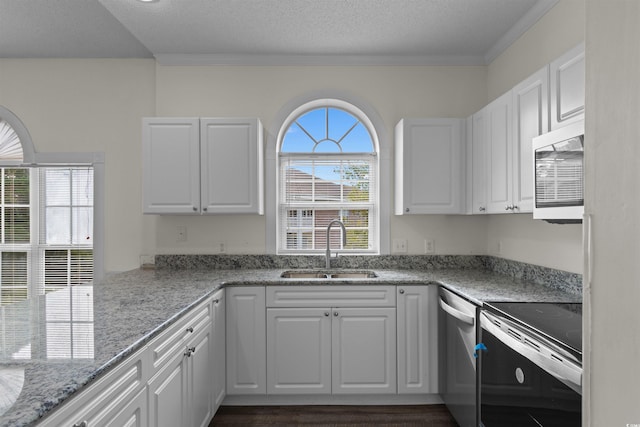 kitchen with light stone countertops, sink, electric range oven, stainless steel dishwasher, and white cabinets