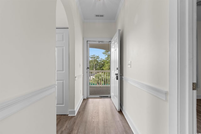 corridor featuring hardwood / wood-style floors and ornamental molding