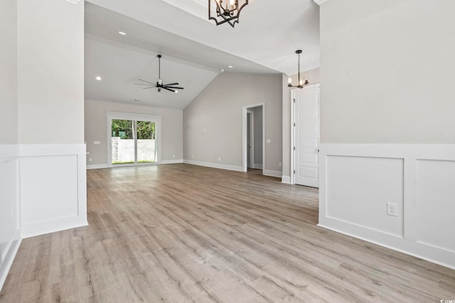 205 Waterfall Cir, Little River, SC 29566 - unfurnished living room with a chandelier, lofted ceiling, light wood-type flooring, a ceiling fan, and a wainscoted wall