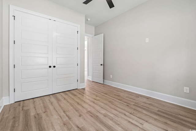 205 Waterfall Cir, Little River, SC 29566 - unfurnished bedroom featuring wood finished floors, a closet, baseboards, and a ceiling fan