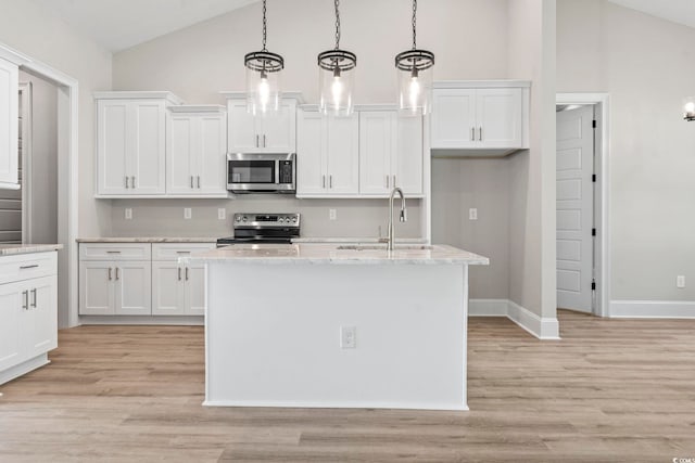 205 Waterfall Cir, Little River, SC 29566 - kitchen featuring appliances with stainless steel finishes, white cabinetry, a kitchen island with sink, high vaulted ceiling, and light wood-style floors