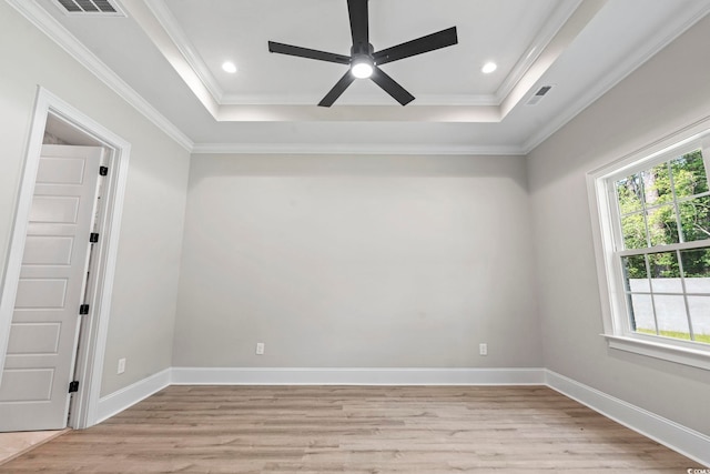 205 Waterfall Cir, Little River, SC 29566 - spare room featuring ceiling fan, a raised ceiling, light wood finished floors, ornamental molding, and recessed lighting