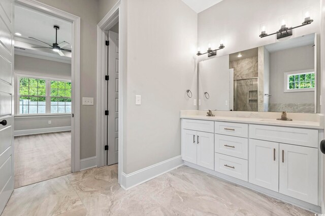 205 Waterfall Cir, Little River, SC 29566 - bathroom featuring marble look tiles, a ceiling fan, double vanity, a tile shower, and healthy amount of natural light