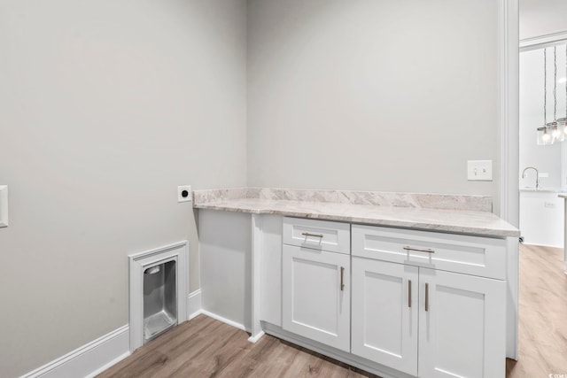 205 Waterfall Cir, Little River, SC 29566 - laundry room with light wood-style flooring, electric dryer hookup, and cabinet space