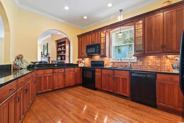 kitchen with black appliances, sink, light hardwood / wood-style floors, ornamental molding, and backsplash