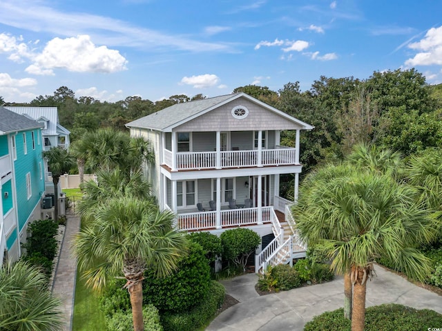 coastal home with covered porch and a balcony