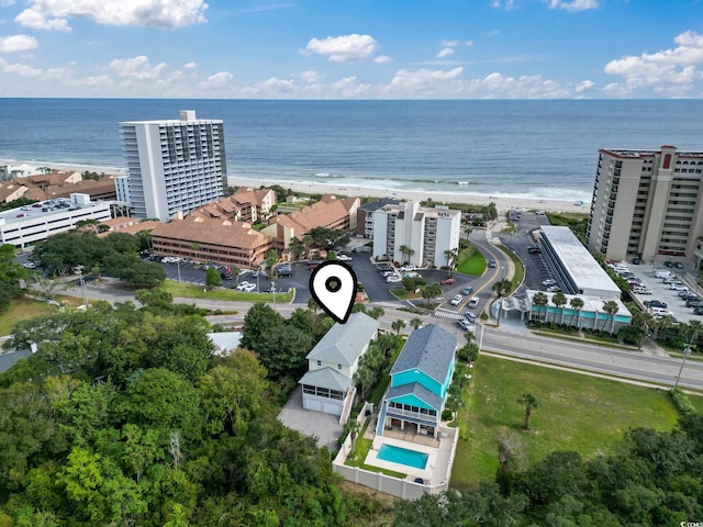 birds eye view of property with a beach view and a water view