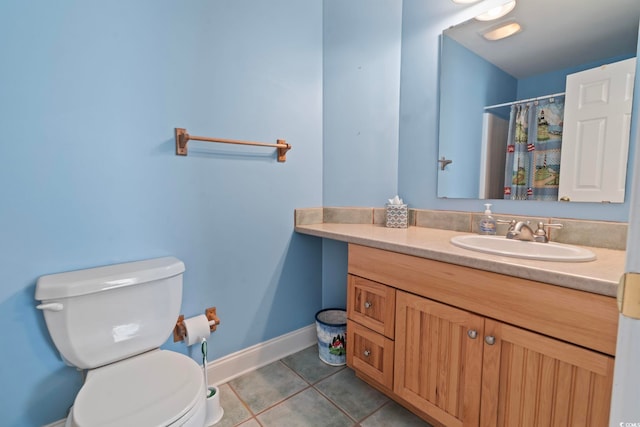 bathroom with vanity, baseboards, curtained shower, tile patterned flooring, and toilet