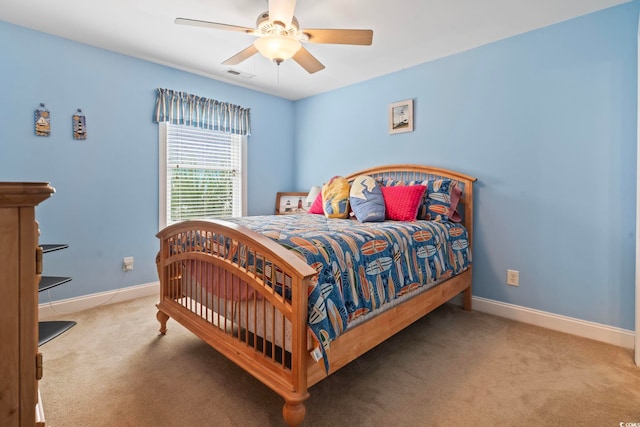 bedroom featuring baseboards, a ceiling fan, visible vents, and carpet floors