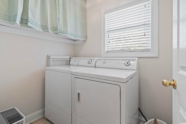 clothes washing area with washing machine and dryer