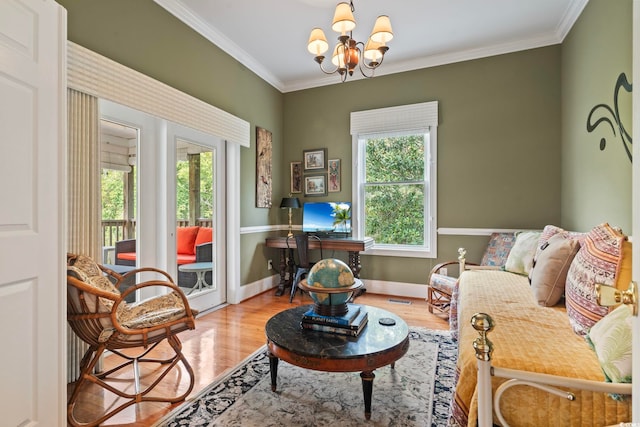 living room with ornamental molding, a chandelier, and light hardwood / wood-style flooring