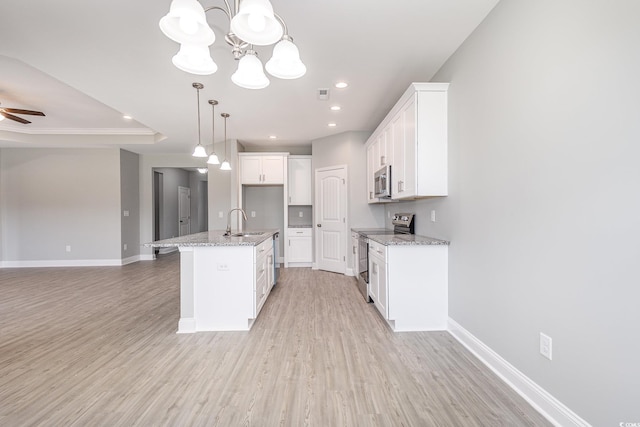 kitchen with a kitchen island with sink, sink, appliances with stainless steel finishes, light hardwood / wood-style floors, and white cabinetry