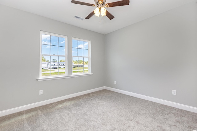 carpeted spare room with ceiling fan