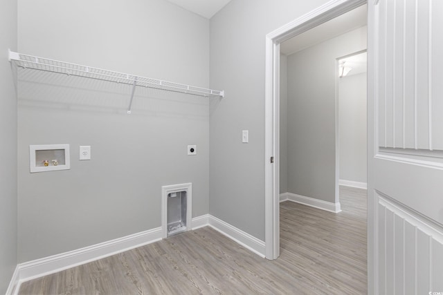 washroom featuring hookup for an electric dryer, light hardwood / wood-style floors, and hookup for a washing machine