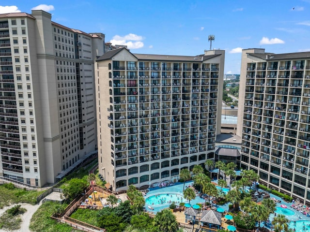 view of building exterior featuring a community pool