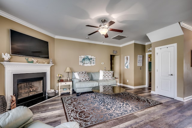 living room with dark wood-type flooring, ornamental molding, and ceiling fan