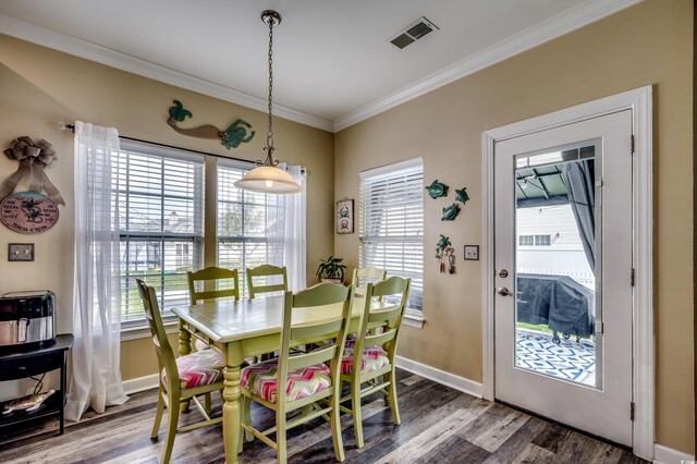 dining room featuring hardwood / wood-style flooring, plenty of natural light, and ornamental molding