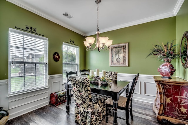 dining room featuring ornamental molding, a chandelier, and dark hardwood / wood-style floors