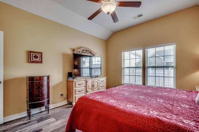 bedroom with ceiling fan, lofted ceiling, and light hardwood / wood-style floors