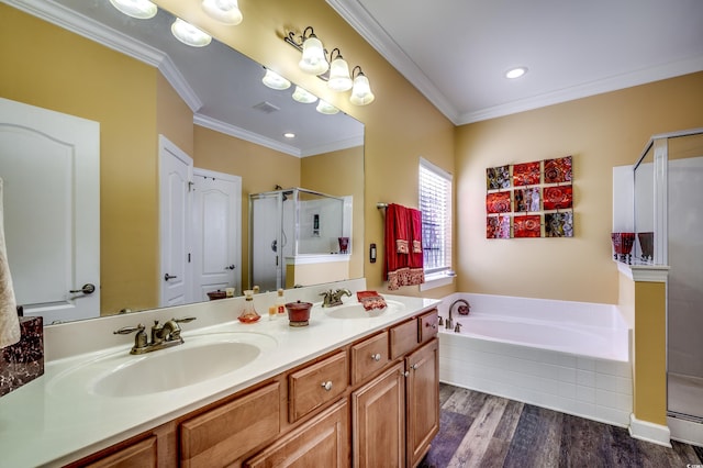 bathroom with hardwood / wood-style flooring, crown molding, separate shower and tub, and vanity