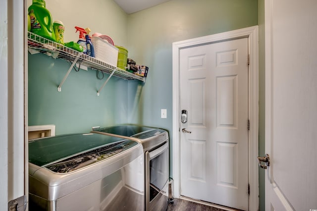 washroom featuring washer and clothes dryer and dark hardwood / wood-style flooring