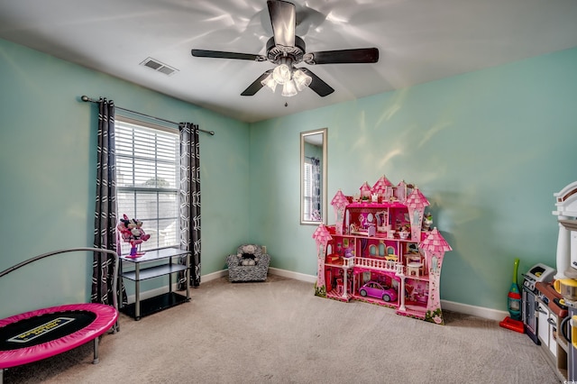 recreation room featuring light carpet and ceiling fan