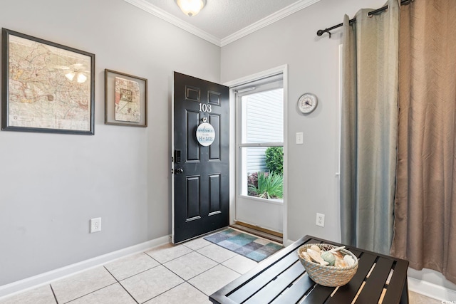 tiled entrance foyer with ornamental molding and a textured ceiling