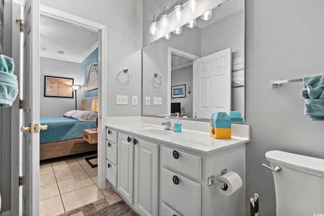 bathroom featuring vanity, crown molding, toilet, and tile patterned flooring