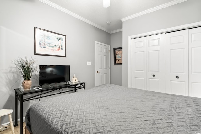 bedroom with a closet, ornamental molding, and a textured ceiling