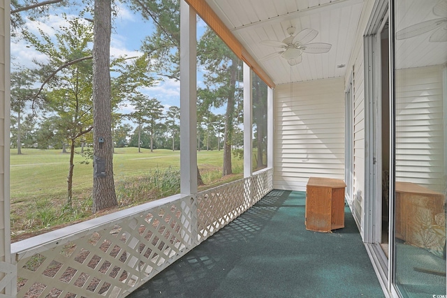 sunroom featuring ceiling fan