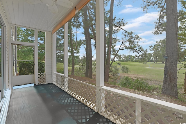 unfurnished sunroom with ceiling fan and a wealth of natural light