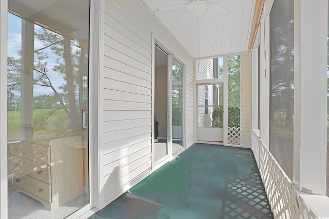 unfurnished sunroom featuring ceiling fan