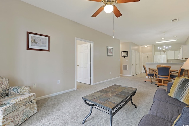 living room featuring light colored carpet and ceiling fan with notable chandelier