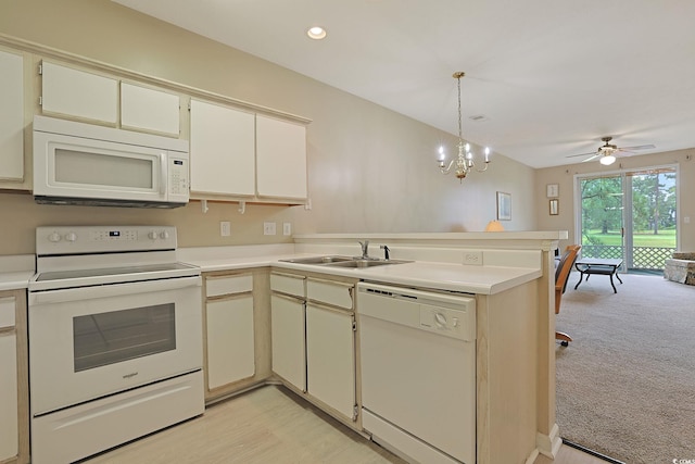 kitchen with hanging light fixtures, kitchen peninsula, sink, white appliances, and ceiling fan with notable chandelier