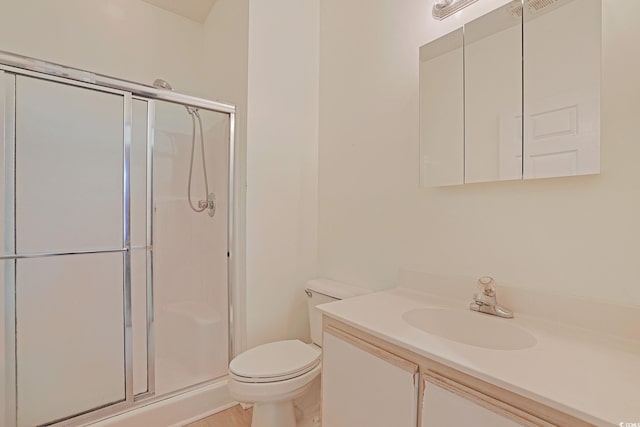 bathroom with walk in shower, vanity, and toilet