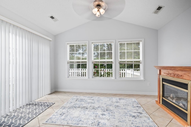 living room with light tile patterned floors, ceiling fan, and lofted ceiling