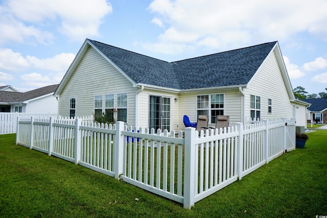 back of house featuring a yard